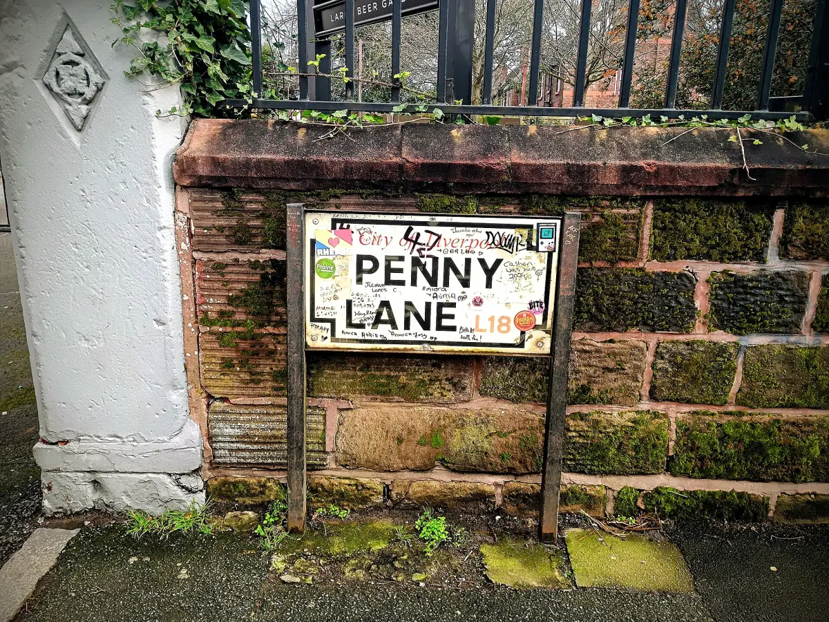 The Penny Lane street sign on a sandstone wall in Liverpool