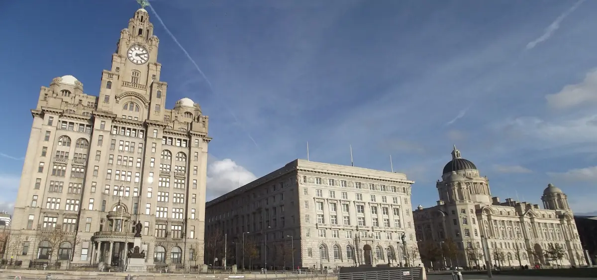The Three Graces on Liverpool's waterfront under a blue sky
